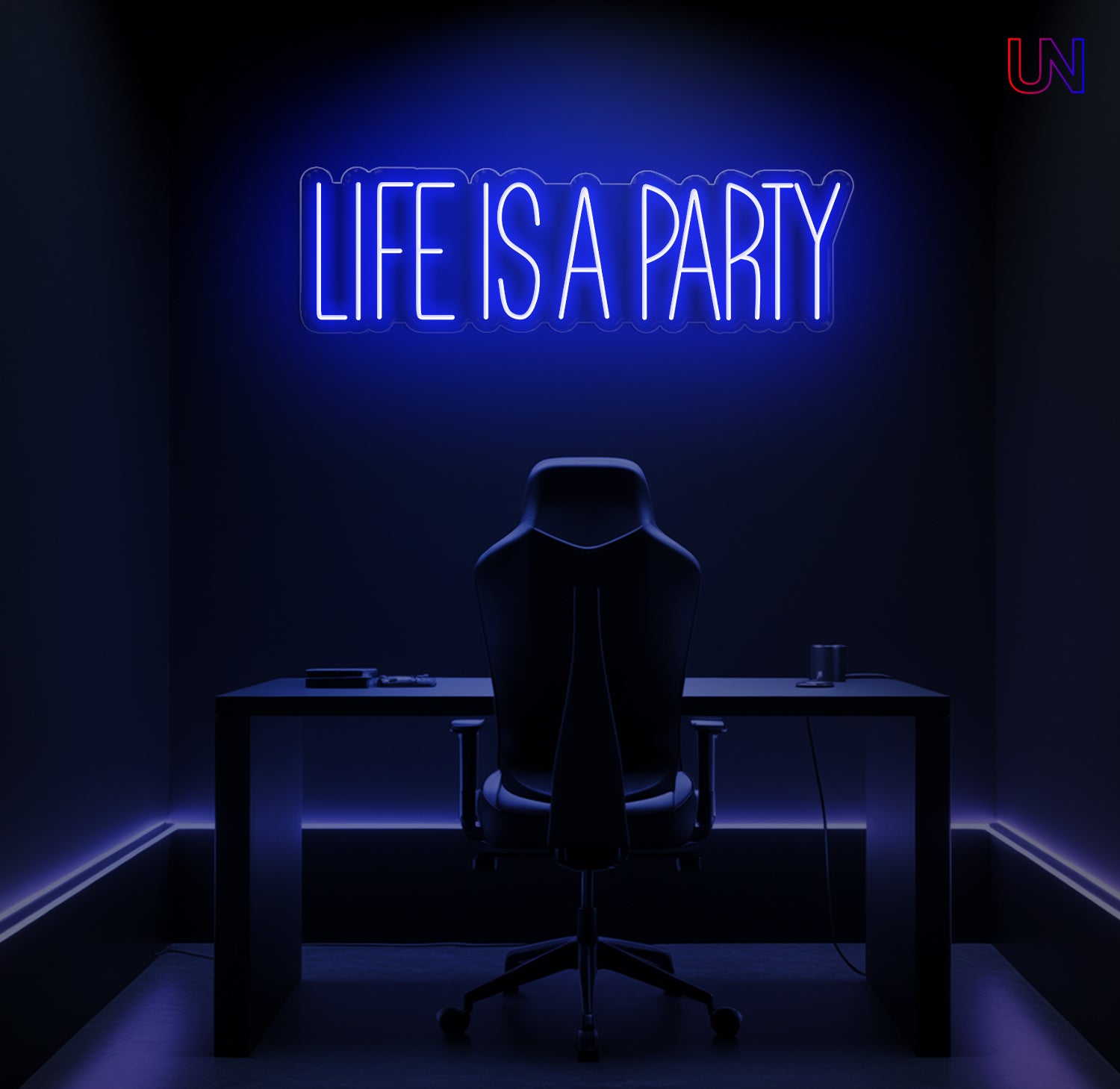 Neon sign with 'Life is a Party' in a dark room with a desk and chair.