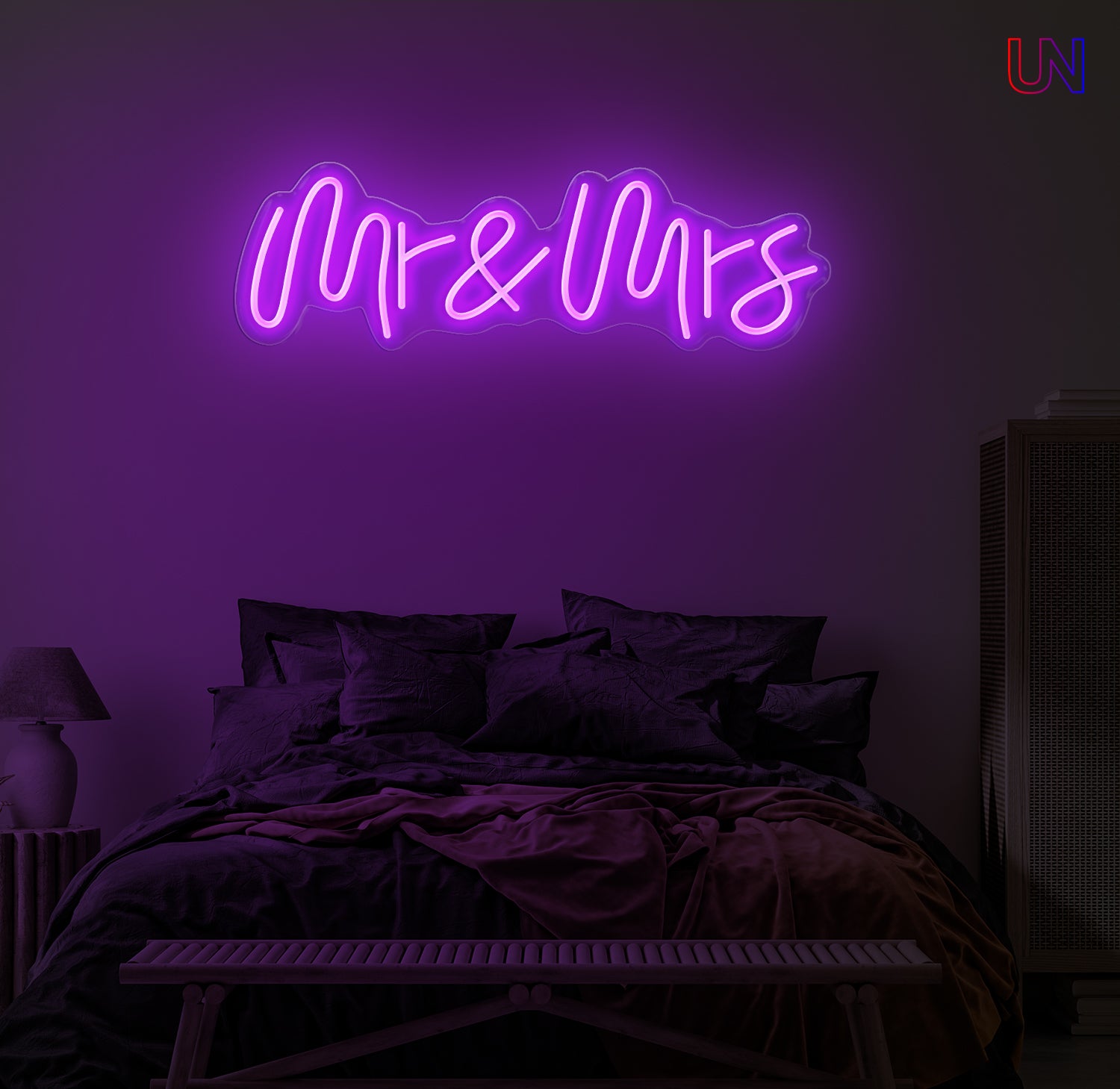 Neon sign reading 'Mr & Mrs' in a bedroom setting with purple lighting.