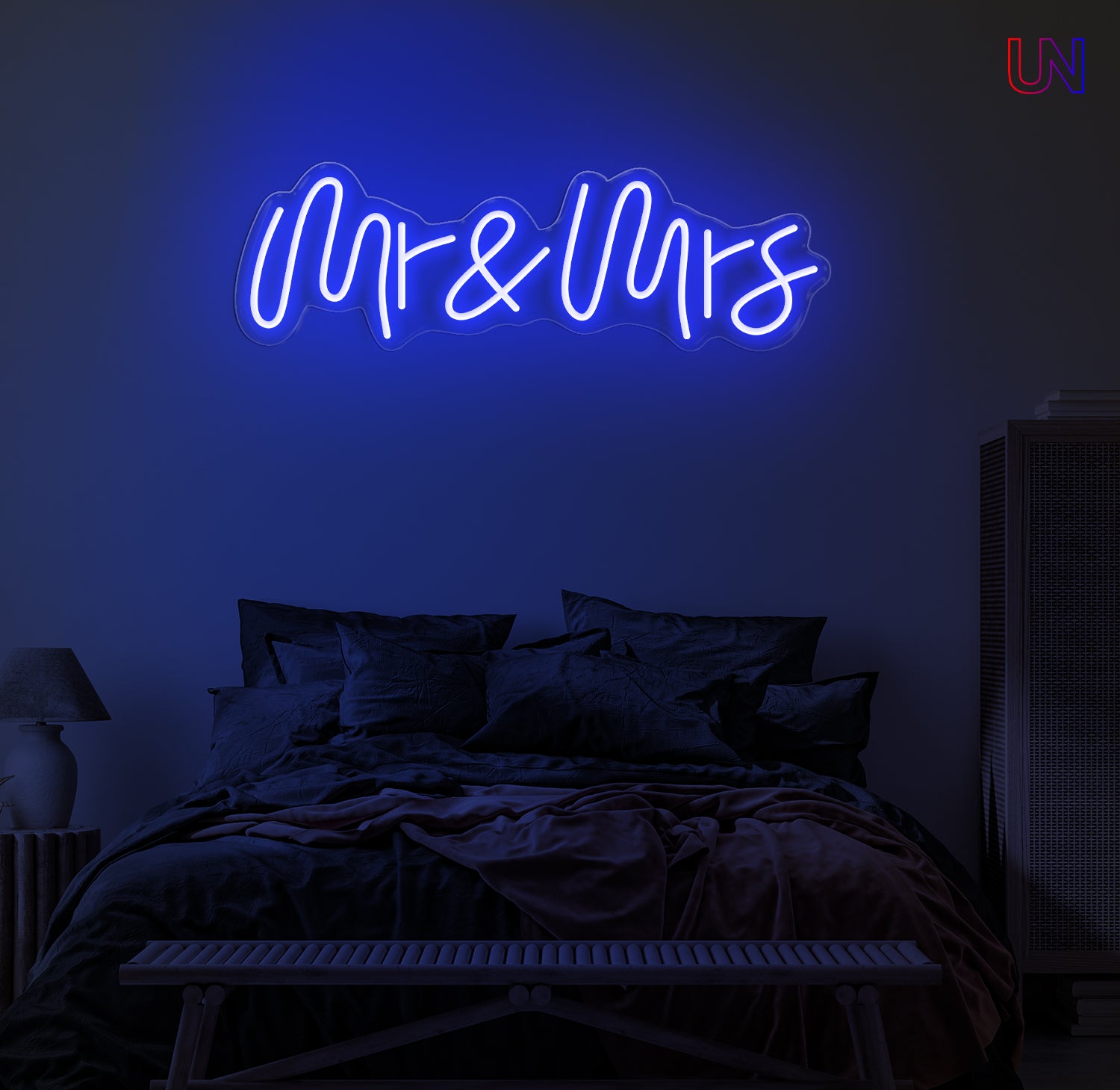 Neon sign reading 'Mr & Mrs' in a bedroom setting.