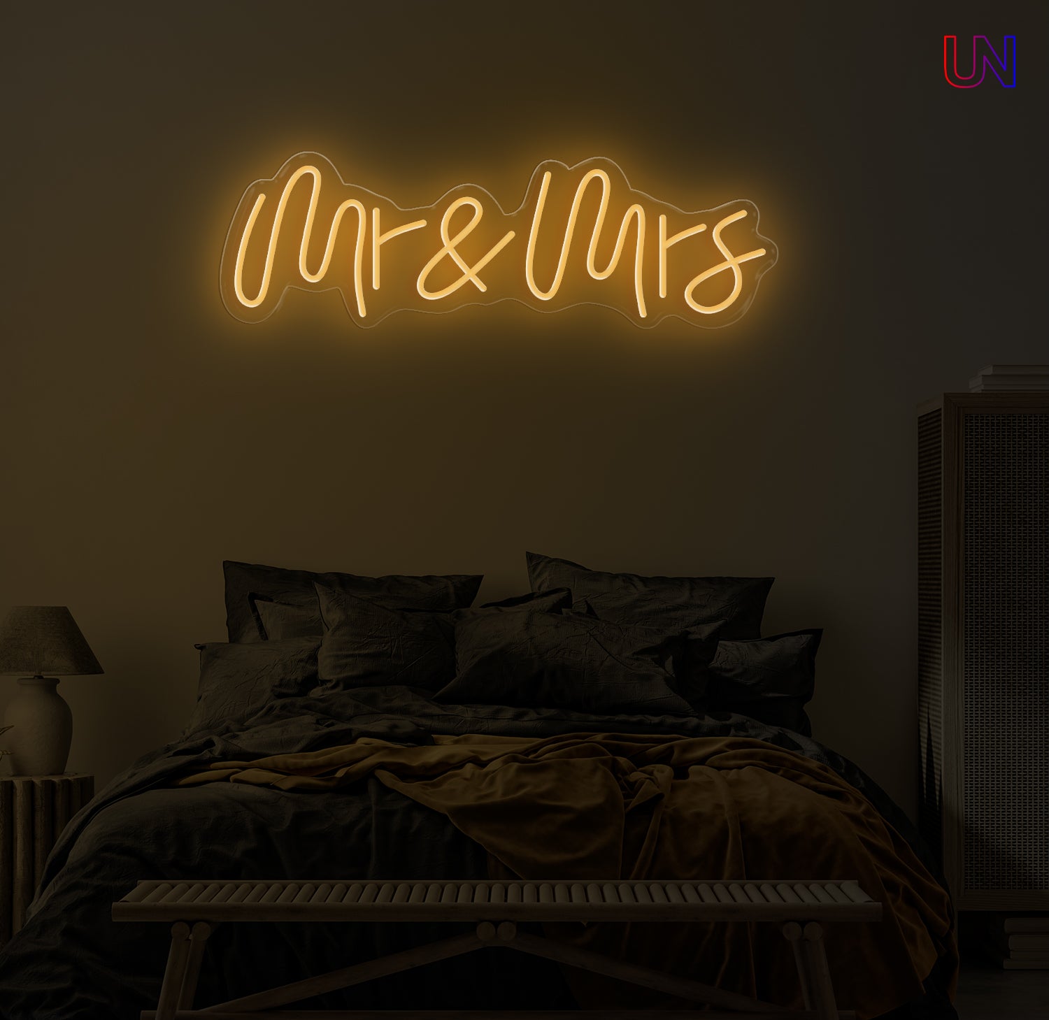 Neon sign reading 'Mr & Mrs' above a bed in a dimly lit room.