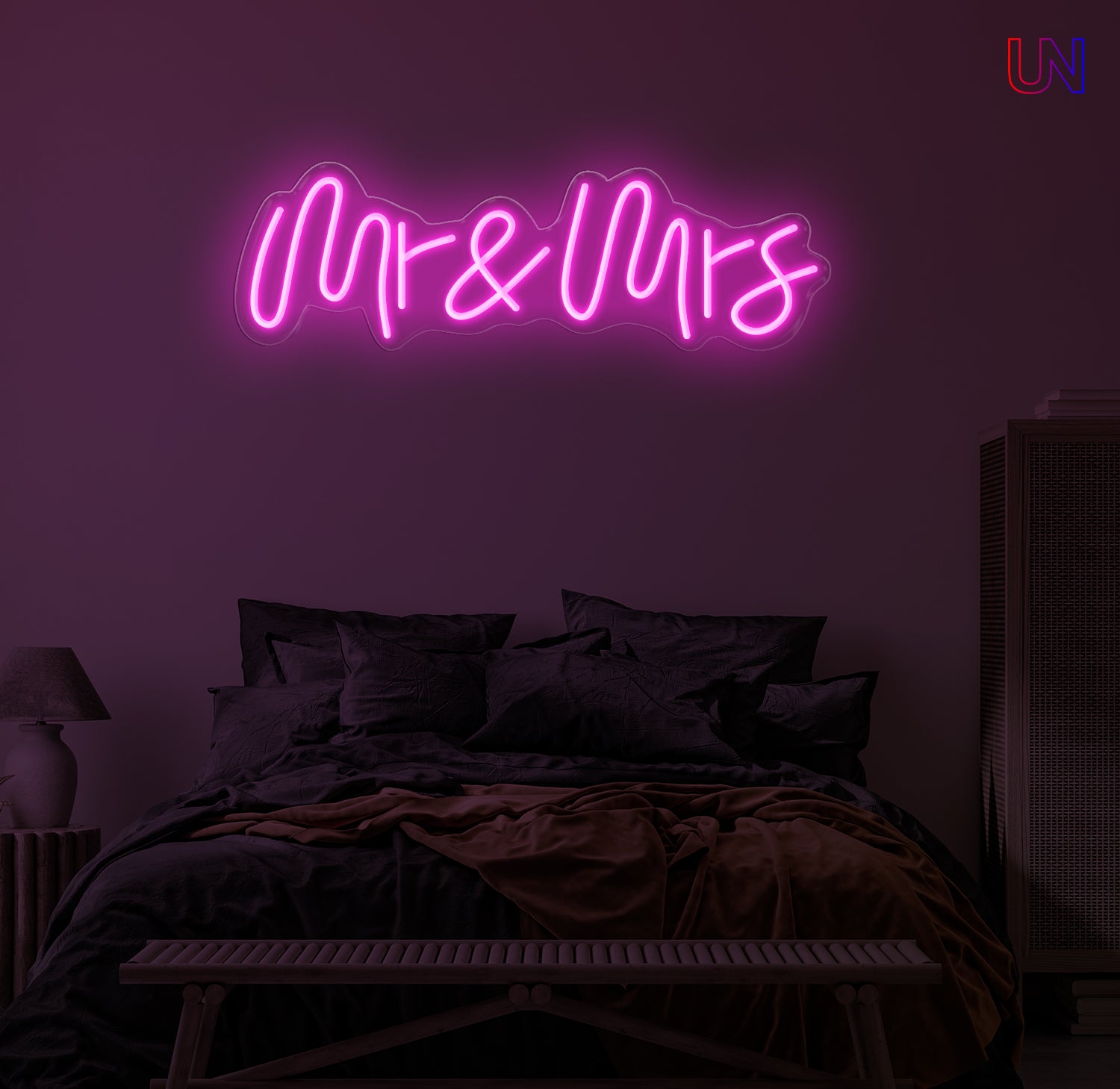 Neon sign with 'Mr & Mrs' in a bedroom setting