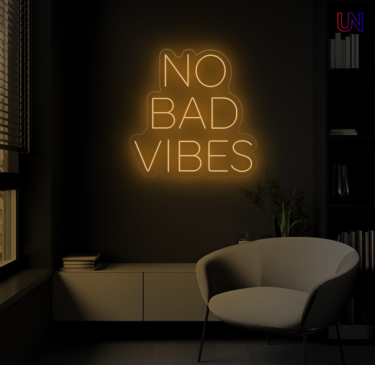 Neon sign with 'No Bad Vibes' in a dark room with a chair and books.
