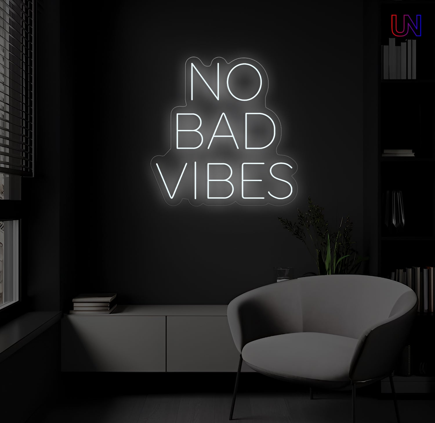 Neon sign with 'No Bad Vibes' in a dark room with a chair and plant.
