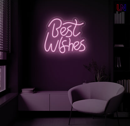 LED neon sign spelling “Best Wishes” glowing on a dark modern wall above a lounge chair