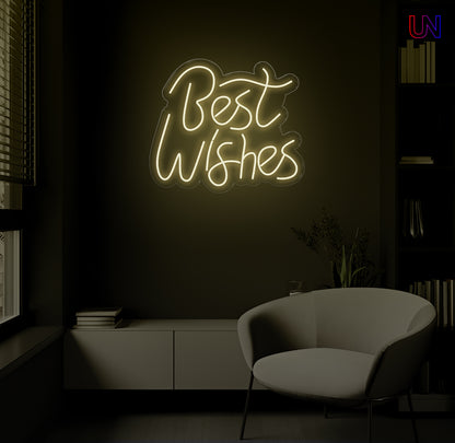LED neon sign spelling “Best Wishes” glowing on a dark modern wall above a lounge chair
