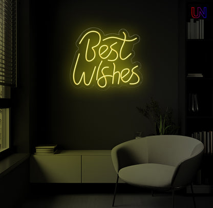 LED neon sign spelling “Best Wishes” glowing on a dark modern wall above a lounge chair