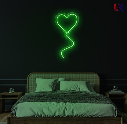 "Heart-shaped balloon neon sign glowing on wall above bed – romantic LED light decor for bedroom or special occasions"


