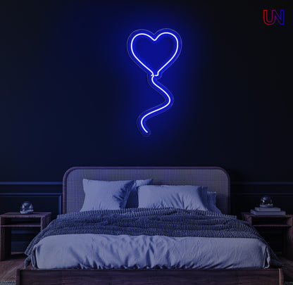 "Heart-shaped balloon neon sign glowing on wall above bed – romantic LED light decor for bedroom or special occasions"
