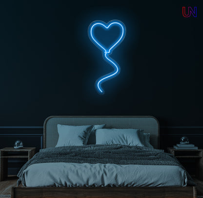 "Heart-shaped balloon neon sign glowing on wall above bed – romantic LED light decor for bedroom or special occasions"

