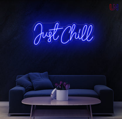 "Just Chill neon sign glowing on wall above sofa – modern LED custom neon wall décor for bedroom, game zone, or lounge area"