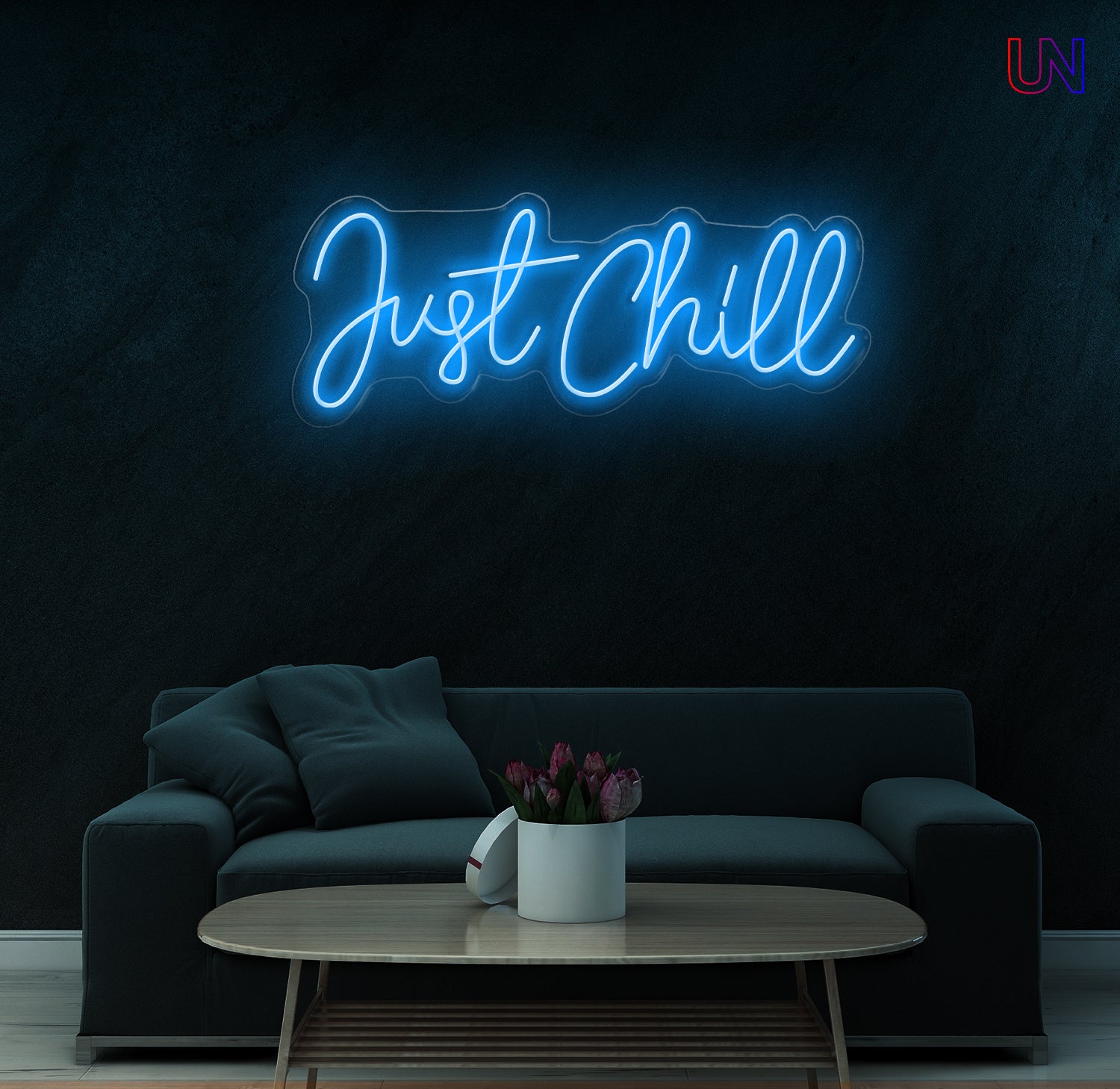 Neon sign reading 'Just Chill' in a living room setting with a dark wall.