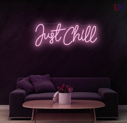 "Just Chill neon sign glowing on wall above sofa – modern LED custom neon wall décor for bedroom, game zone, or lounge area"