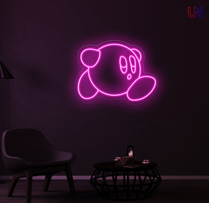 Kirby-inspired custom neon sign glowing on the wall in a modern lounge space.