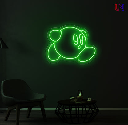 Kirby-inspired custom neon sign glowing on the wall in a modern lounge space.
