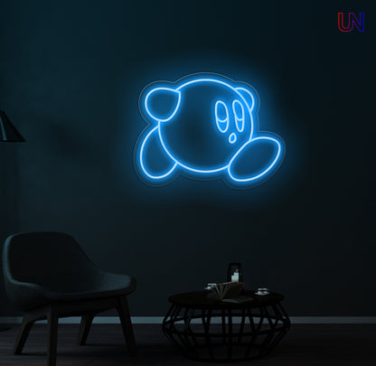 Neon light shaped like a cartoon character on a dark wall with a chair and table in the foreground.