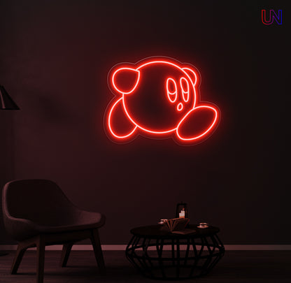 Kirby-inspired custom neon sign glowing on the wall in a modern lounge space.