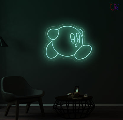 Glowing neon sign of a cartoon character on a dark wall with minimal furniture.