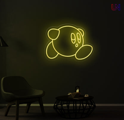 Kirby-inspired custom neon sign glowing on the wall in a modern lounge space.