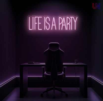 Neon sign reading 'Life is a Party' above a desk in a dark room.